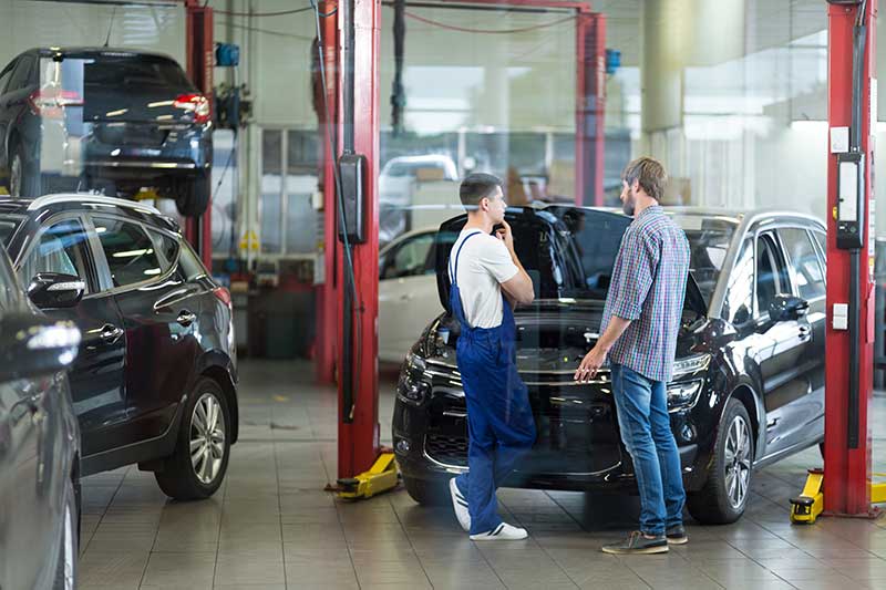 car mechanic talking to customer car mechanic talking to customer